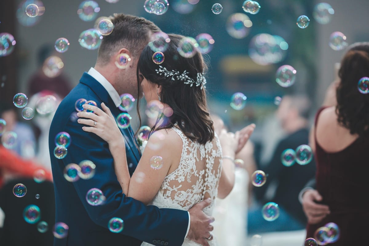 Bubble Machine hire — newlyweds embracing surrounded by festive bubbles | Panda Party Hire Hire bubble machine — newlyweds embracing surrounded by festive bubbles for parties and events in Johannesburg, Sandton and Randburg