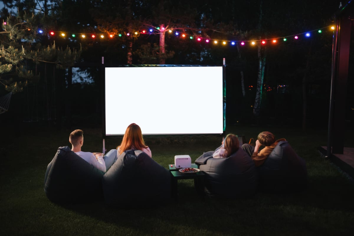 Outdoor Cinema hire — friends enjoying outdoor movie night on lawn | Panda Party Hire Hire outdoor cinema — friends enjoying outdoor movie night on lawn for parties and events in Johannesburg, Sandton and Randburg