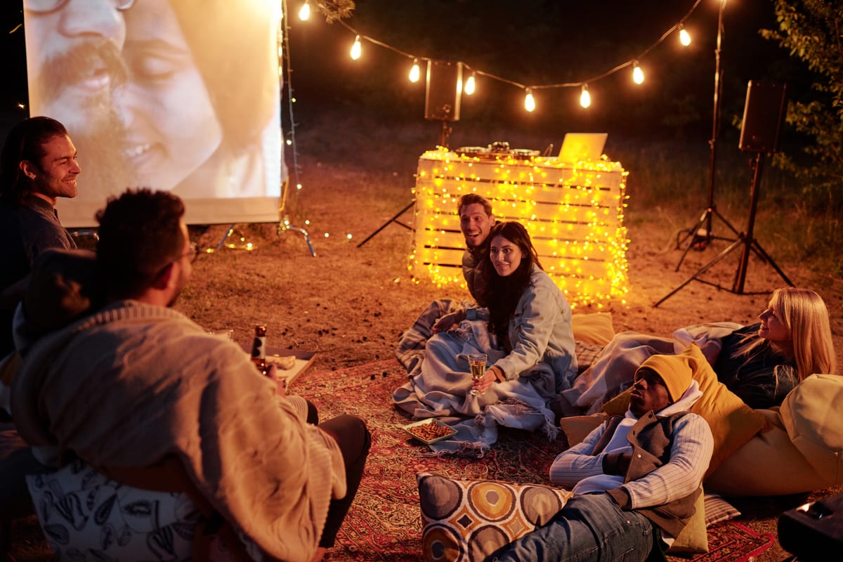 Outdoor Cinema hire — friends enjoying outdoor movie night under string | Panda Party Hire Hire outdoor cinema — friends enjoying outdoor movie night under string for parties and events in Johannesburg, Sandton and Randburg