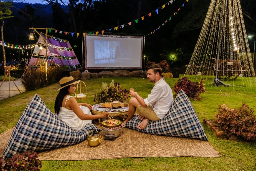 Outdoor Cinema hire — couple watching a movie at an outdoor cinema film | Panda Party Hire Hire outdoor cinema — couple watching a movie at an outdoor cinema film for parties and events in Johannesburg, Sandton and Randburg