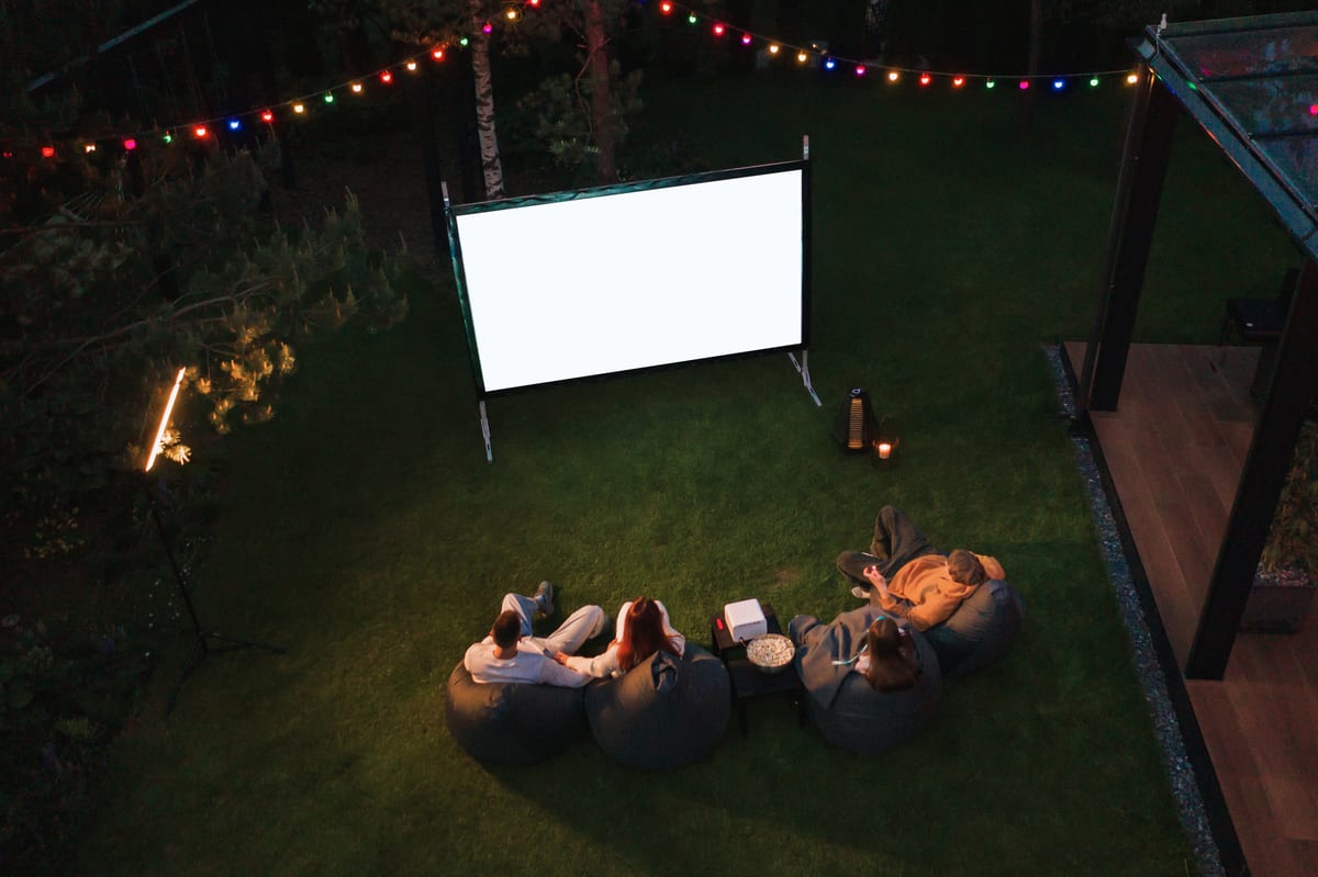 Outdoor Cinema hire — family watch movie outdoor in backyard at night | Panda Party Hire Hire outdoor cinema — family watch movie outdoor in backyard at night for parties and events in Johannesburg, Sandton and Randburg