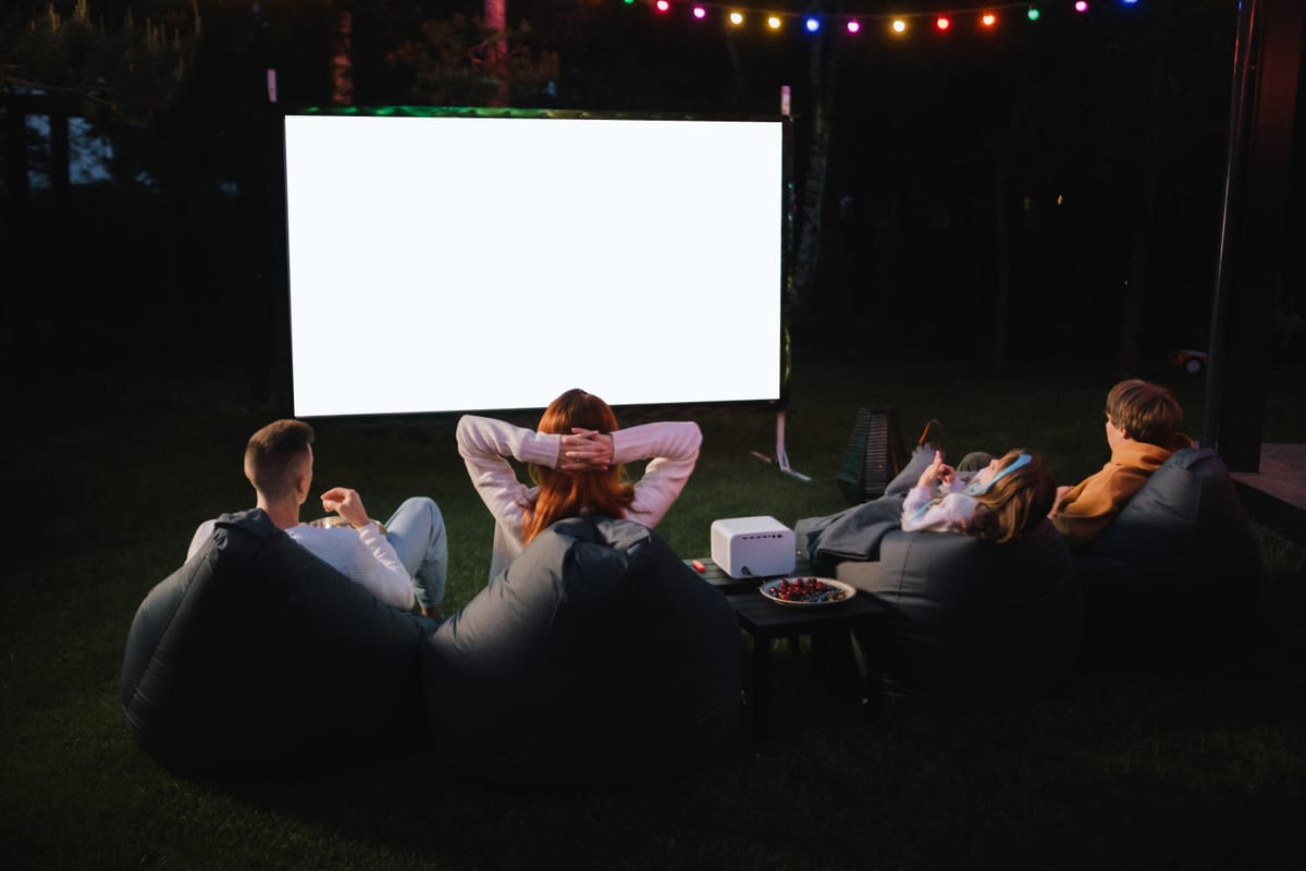 Outdoor Cinema hire — friends enjoying an outdoor movie night on lawn | Panda Party Hire Hire outdoor cinema — friends enjoying an outdoor movie night on lawn for parties and events in Johannesburg, Sandton and Randburg