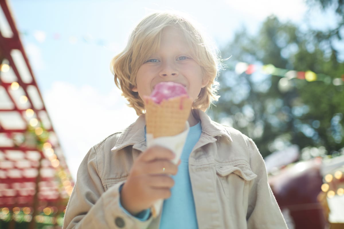 Soft Serve Machine hire — smiling child enjoys ice cream cone outdoors | Panda Party Hire Hire soft serve machine — smiling child enjoys ice cream cone outdoors for parties and events in Johannesburg, Sandton and Randburg