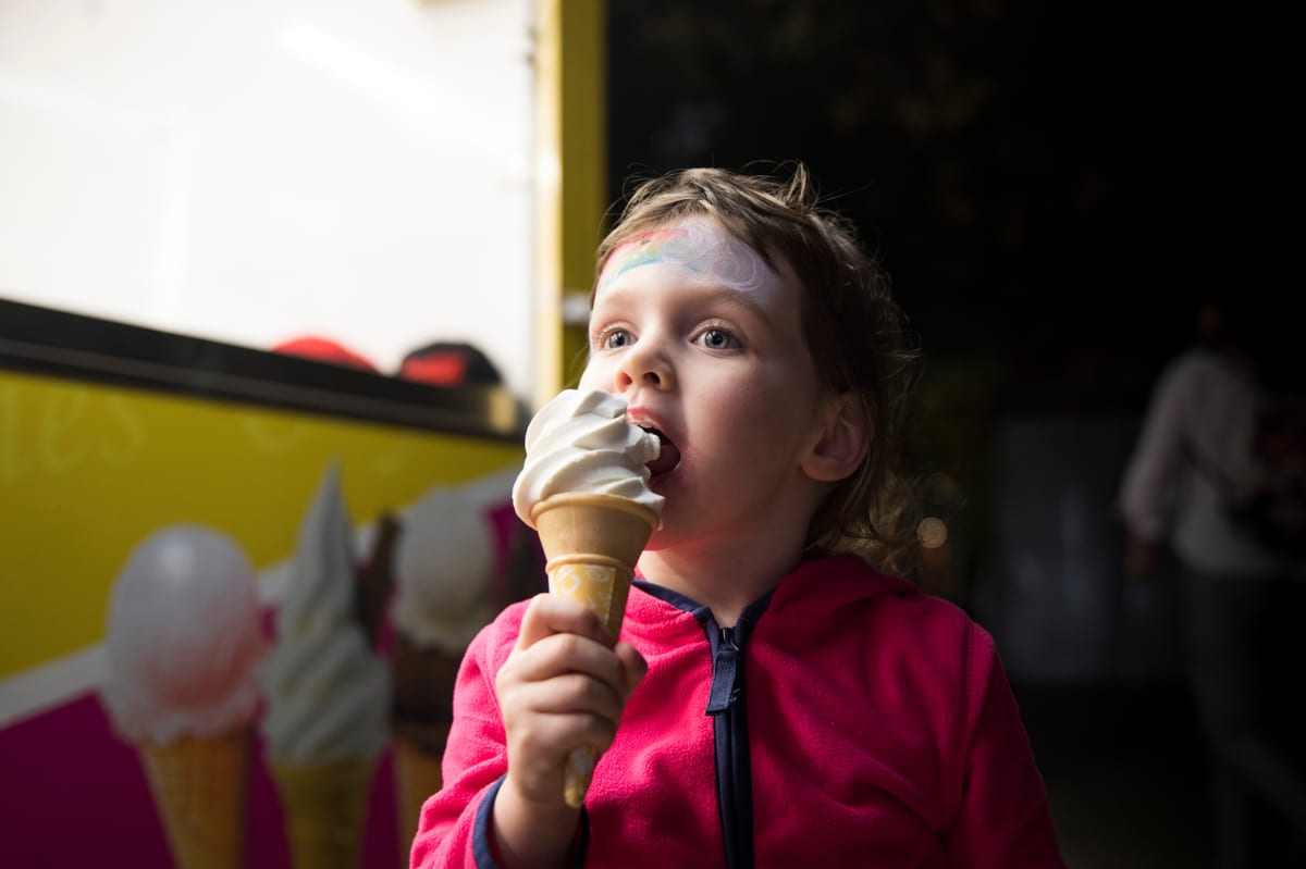 Soft Serve Machine hire — child enjoying ice cream by a food truck | Panda Party Hire Hire soft serve machine — child enjoying ice cream by a food truck for parties and events in Johannesburg, Sandton and Randburg