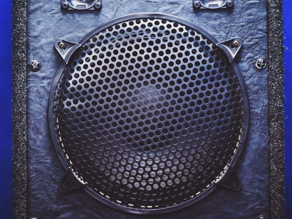Sound System hire — speaker grille close up on blue textured backgroun | Panda Party Hire Hire sound system — speaker grille close up on blue textured backgroun for parties and events in Johannesburg, Sandton and Randburg